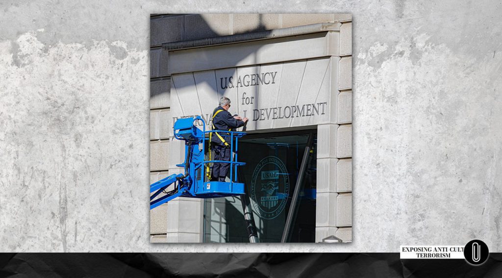 A worker removes the sign “U.S. Agency for International Development” from its headquarters on February 7, 2025, in Washington, D.C.