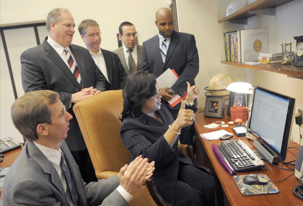 Baltimore mayor Stephanie Rawlings-Blake submitting an application at City Hall. David Troy is behind her, in the middle  